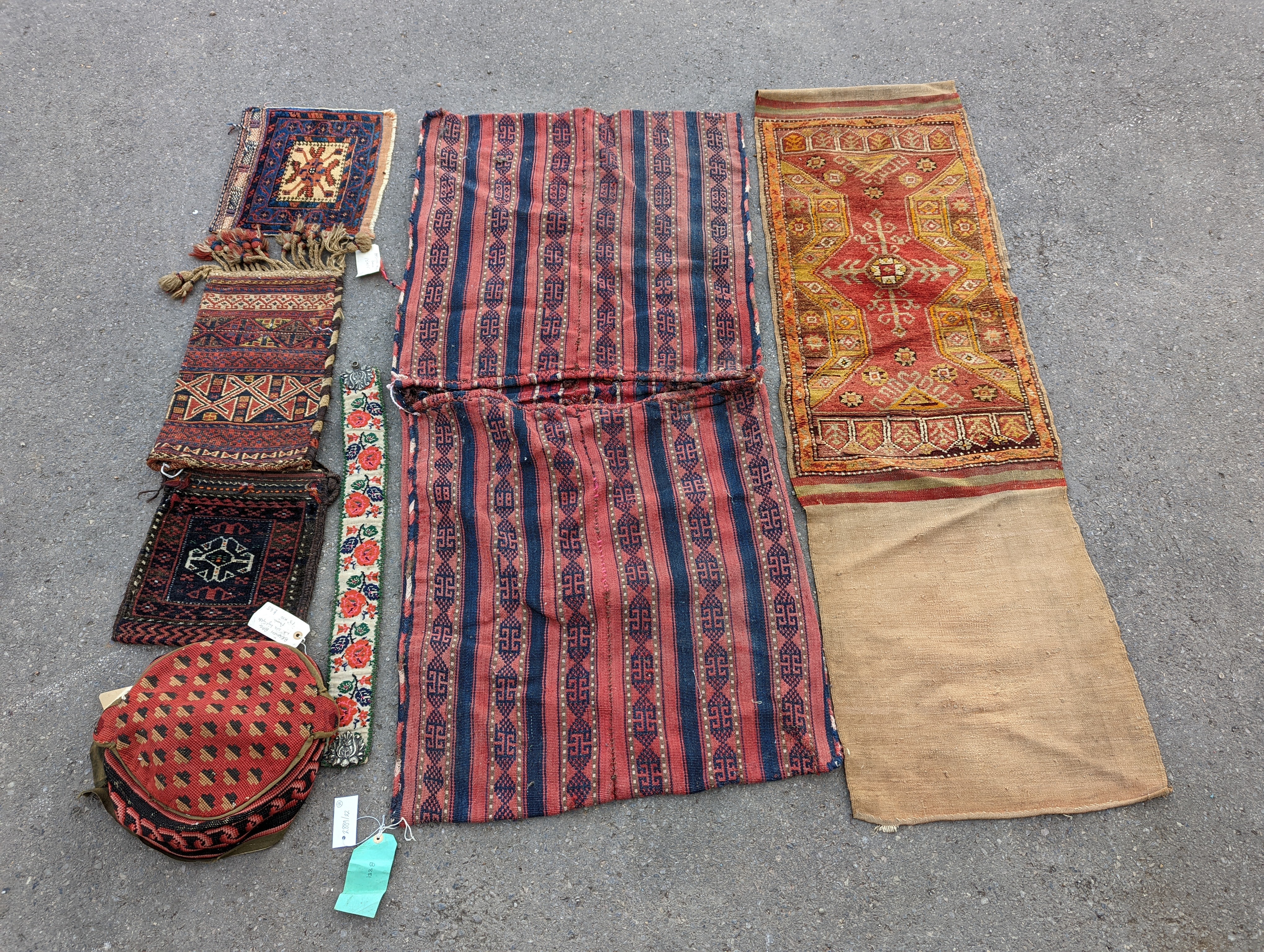 An Afghan Kilim flatweave saddlebag, 144 x 69cm together with six assorted bags, faces, etc.